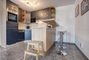 eine Küche mit Holzhockern und einer Arbeitsplatte in der Unterkunft Ostseeresidenz Gorki- Park - 23 mit Wellness und Schwimmbad in Bansin