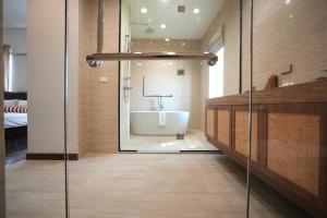 a bathroom with a bath tub and a sink at La Villa des Chien in Ban Nong Chap Tao +87 photos
