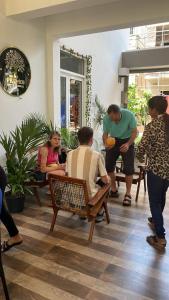 a group of people sitting in a room at Wellness Residency in Colombo