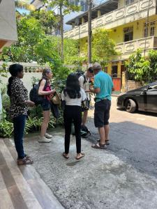 a group of people standing on the side of a street at Wellness Residency in Colombo