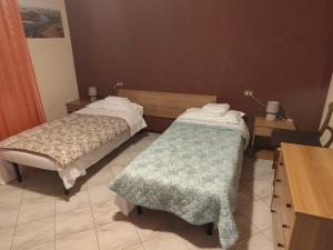 a room with two beds and a table with a desk at Appartamento a due passi da Mantova in Curtatone