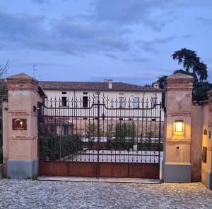 a gate in front of a house at Dimora Rosaspina Suite Eden e Suite Platinum in Adro