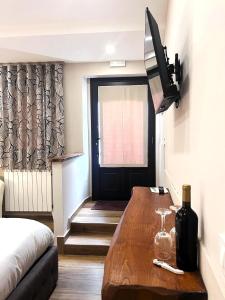 a living room with a wooden table and a television at Rifugio AL in Randazzo