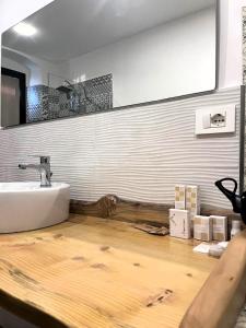 a bathroom with a sink and a mirror on the wall at Rifugio AL in Randazzo +3 photos