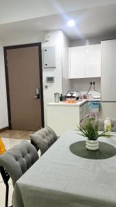 a kitchen with a table and chairs and a kitchen with a counter at High floor City view 2BR condo in Johor Bahru