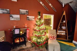 a living room with a christmas tree and a fireplace at Burleigh Falls Inn in Burleigh Falls