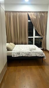 a bedroom with a bed and a window with a view at High floor City view 2BR condo in Johor Bahru