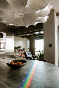 a bowl of fruit on a table with a rainbow at Luxury Waterfront Loft with Panoramic Views in Caminha