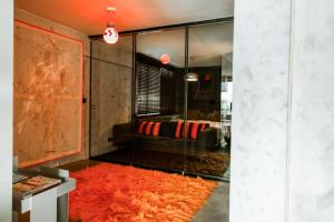 a living room with a red rug on the floor at Luxury Waterfront Loft with Panoramic Views in Caminha
