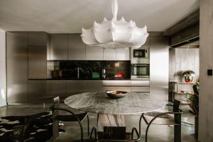 a kitchen with a table and a chandelier at Luxury Waterfront Loft with Panoramic Views in Caminha