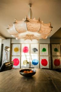 a bowl of fruit on a table with a chandelier at Luxury Waterfront Loft with Panoramic Views in Caminha