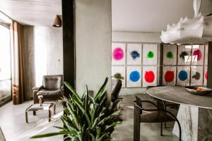 a living room with a table and chairs and a plant at Luxury Waterfront Loft with Panoramic Views in Caminha +26 photos