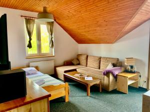 a living room with a couch and a table at Aqualand Penzion - free parking in Poprad