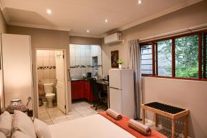 a kitchen with a white refrigerator in a room at Son Heuwel B&B room in Nelspruit