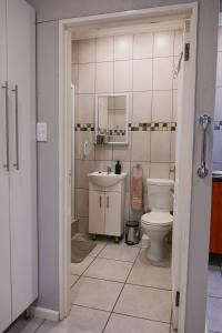 a bathroom with a sink and a toilet at Son Heuwel B&B room in Nelspruit +12 photos