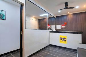 an office lobby with a ticket counter and a door at FabHotel Demattrie Budget in Kolkata