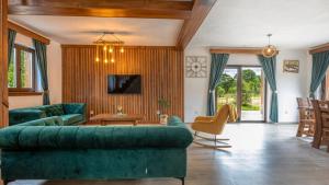 a living room with a green couch and a table at Villa D-Ika by Villas Guide in Brušane