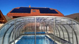 a glass greenhouse with a swimming pool on top of it at Villa D-Ika by Villas Guide in Brušane