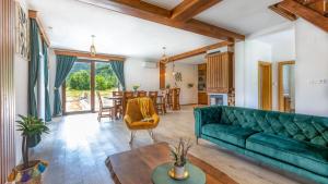 a living room with a green couch and a table at Villa D-Ika by Villas Guide in Brušane