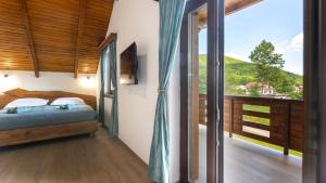 a bedroom with a bed and a large window at Villa D-Ika by Villas Guide in Brušane +20 photos