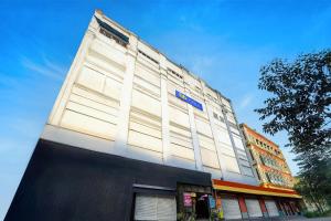 a building with a blue sign on the side of it at FabHotel Demattrie Budget in Kolkata