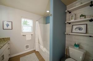 a bathroom with a shower and a toilet in it at Hydrangea Hideaway in Ocean Shores +32 photos