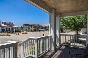 a porch with a view of a street with houses at Hydrangea Hideaway in Ocean Shores