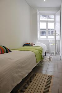 Postel nebo postele na pokoji v ubytování Down Bonjardim Apartments