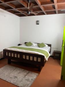 a bedroom with a bed in a white wall at Colonial canopy in Suntikoppa