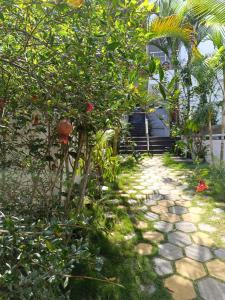 a garden with a tree and a stone path at Misty Hills in Yercaud