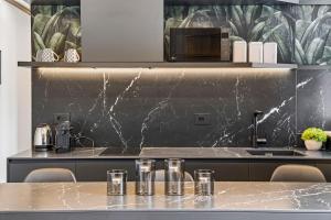 a kitchen with a table with glasses on it at Appartamento Porta Torre - Porta Torre-Centro in Como
