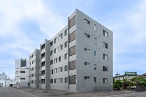a tall gray building with many windows at Grandia 302 in Sapporo