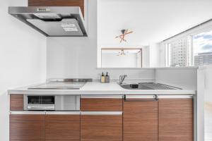 a kitchen with a sink and a microwave at Grandia 302 in Sapporo +70 photos