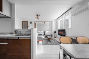 a kitchen with a sink and a living room at Grandia 302 in Sapporo