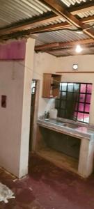 a kitchen with a counter and a window in a room at Yua Residence in Machakos