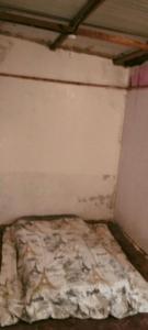 a corner of a room with a wall and a bed at Yua Residence in Machakos