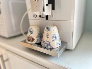 two blue and white vases on a shelf next to a microwave at Tiny flat - in medieval Ystad in Ystad +21 photos