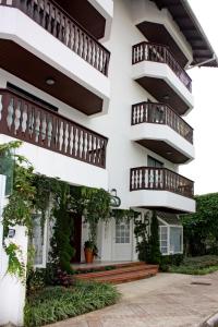 a building with balconies and plants on it at Villa Germânia in Balneário Camboriú