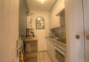 a small kitchen with a sink and a stove at Antares 402 au centre a Anzere in Anzère