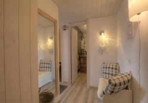 a hallway with a mirror and a bed in a room at Antares 402 au centre a Anzere in Anzère