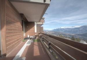 a balcony of a house with a view of mountains at Antares 402 au centre a Anzere in Anzère