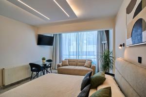 a living room with a couch and a chair at Marianna Hotel Apartments in Limassol