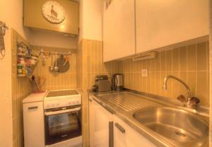 a small kitchen with a sink and a counter top at Antares 403 au centre a Anzere in Anzère