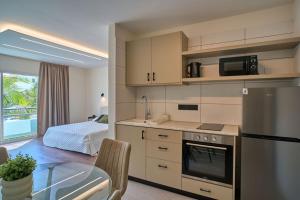 a kitchen and dining room with a table and a microwave at Marianna Hotel Apartments in Limassol