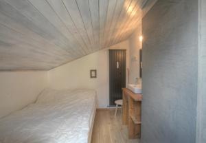 a small bedroom with a bed and a sink at Antares 507, au centre a Anzere in Anzère