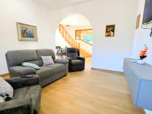 a living room with a couch and two chairs at VILLA SEA VIEW IN SICILY, Real Relax in Fontane Bianche