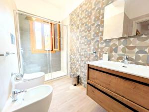a bathroom with a sink and a toilet and a mirror at VILLA SEA VIEW IN SICILY, Real Relax in Fontane Bianche +10 photos