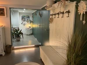 a hallway with a door and a table in a room at Gîte EMOZIONE in Guebwiller +11 photos
