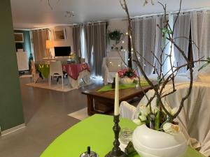 a living room with a table with a candle on it at Gîte EMOZIONE in Guebwiller