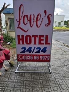 a sign for a love hotel on the side of a street at Love's Hotel in Nhơn Trạch